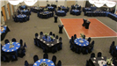 Aerial view of Royal wedding reception of black and blue table settings with dance floor in the midd